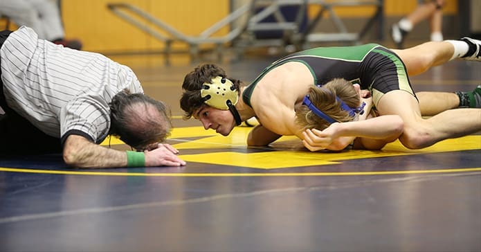 Noah Kile , top right, of Blessed Trinity High School, Roswell, looks at over referee Tom Dursee for a signal declaring him the winner. Eventually Kile would win the 126-pound match after pinning Davis Kirkland of St. Pius X High School, Atlanta. Photo By Michael Alexander