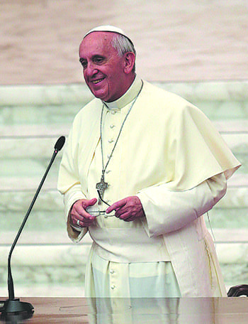 Pope Francis smiles during a meeting with catechists in the Paul VI hall at the Vatican Sept. 27. The church needs good catechists, who love Christ, live out the Gospel in their lives and courageously go to the margins of society to share the gift of faith with others, the pope told catechists from around the world. CNS photo/Tony Gentile, Reuters