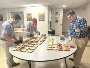 College students prepare sandwiches as part of outreach to people living on the streets in Athens, Ga.