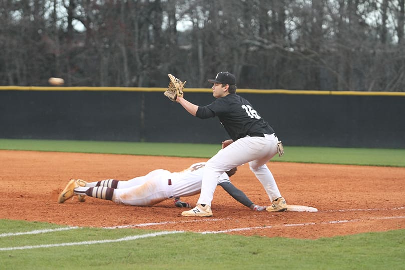 The throw to Pinecrest Academy first baseman JoeyKiernan (#16) during the bottom of the seventh inning is not in time, as Walker short stop Gino Groover gets back to the bag. Pinecrest defeated The Walker School 7-2 in the first game of a March 11 doubleheader. Photo By Michael Alexander