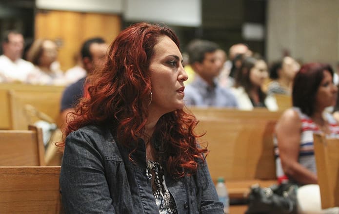 Wenda Vaz joins the congregation in singing the responsorial psalm during the evening Portuguese Mass at Holy Family Church in Marietta. Vaz, a native of the Brazilian city, Goiania, has been a member of Atlanta's Brazilian Catholic community for 14 years. Photo By Michael Alexander