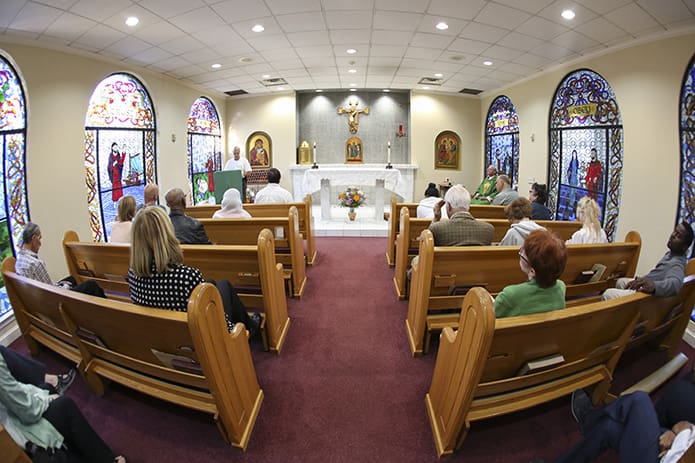 Tony Rozier, standing at the lectern, reads from the fifth chapter of Ephesians during the 5:30 p.m. weekday Mass in the parish chapel. Photo By Michael Alexander