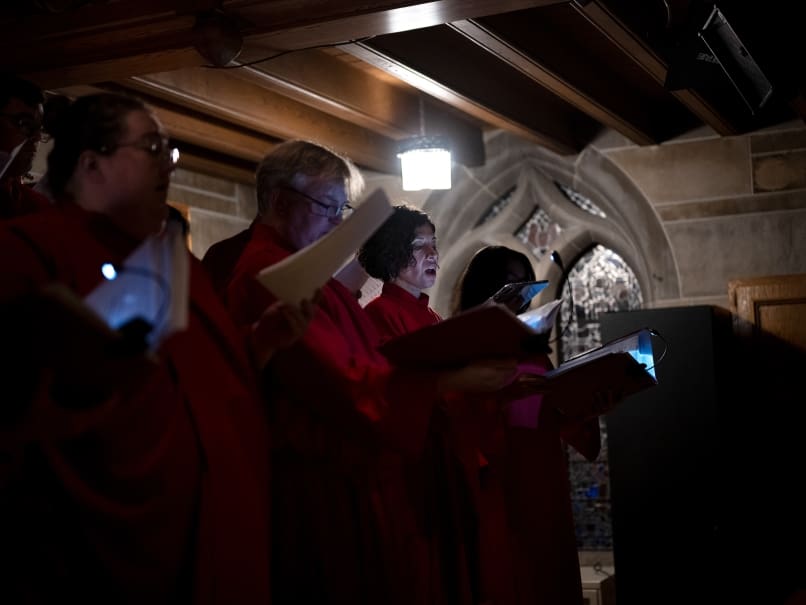 The choir sings the liturgy during a Tenebrae service at Cathedral of Christ of the King. Tenebrae is a solemn prayer service of song and ure, marked by the gradual extinguishing of lights until the service ends in darkness and silence. Photo by Johnathon Kelso