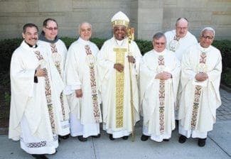 Archbishop Wilton D. Gregory, center, poses with the 2013 silver and golden jubilee priests. They include (l-r) silver jubilarians Missionaries of the Nativity of Mary Father Jaime Molina and Conventual Franciscan Father John Koziol, golden jubilarian Msgr. Frank Giusta, silver jubilarians Father Philip Ryan and Dominican Father Bruce Schultz and golden jubilarian Missionary Society of St. Francis de Sales Father Joseph Mendes.