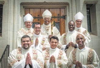 Archbishop Wilton D. Gregory ordained five men as transitional deacons on May 25 at the Cathedral of Christ the King, Atlanta. Shown are: (back row, l-r) Bishop David P. Talley, Archbishop Gregory and Bishop Luis R. Zarama; (middle row, l-r) Rev. Mr. Brian Baker and Rev. Mr. Junot Nelvy; (front row, l-r) Rev. Mr. Luis Alvarez, Rev. Mr. Rey Pineda and Rev. Mr. Desmond Drummer.