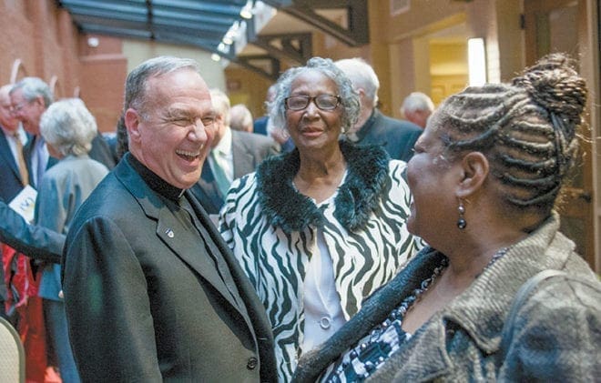 Many people, including Marist School president, Marist Father John Harhager, enjoy the reception following Mass which included fellowship and a meal. On display were several panels, articles, maps and archival material recounting the history of the Marists in the United States.