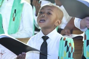 Three-year-old Toritsé Edun only stands three feet, two inches, but he stood tall when it came to singing with fellow children choir members during the annual Martin Luther King Jr. Eucharistic Celebration. Photo By Michael Alexander