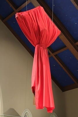 In the days leading up to the passion and death of Christ, the crucifix is draped in red. Photo By Michael Alexander
