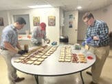 College students prepare sandwiches as part of outreach to people living on the streets in Athens, Ga.