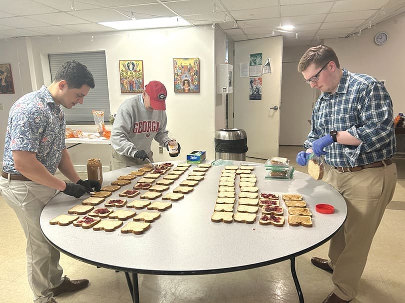 College students prepare sandwiches as part of outreach to people living on the streets in Athens, Ga.